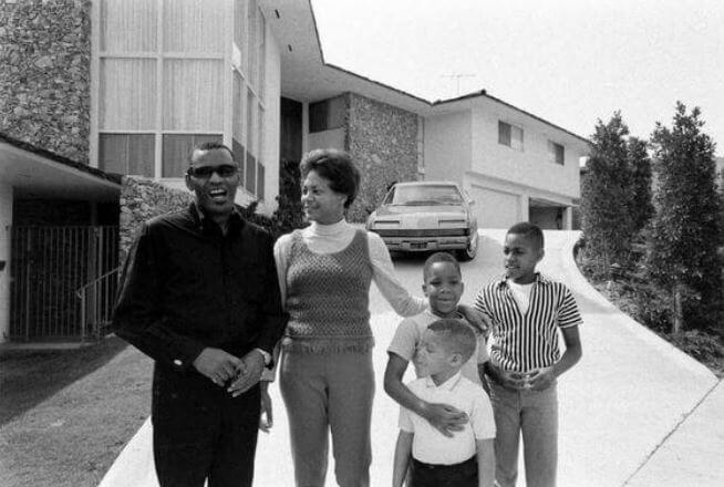 Della Beatrice Howard Robinson with her former husband and sons.